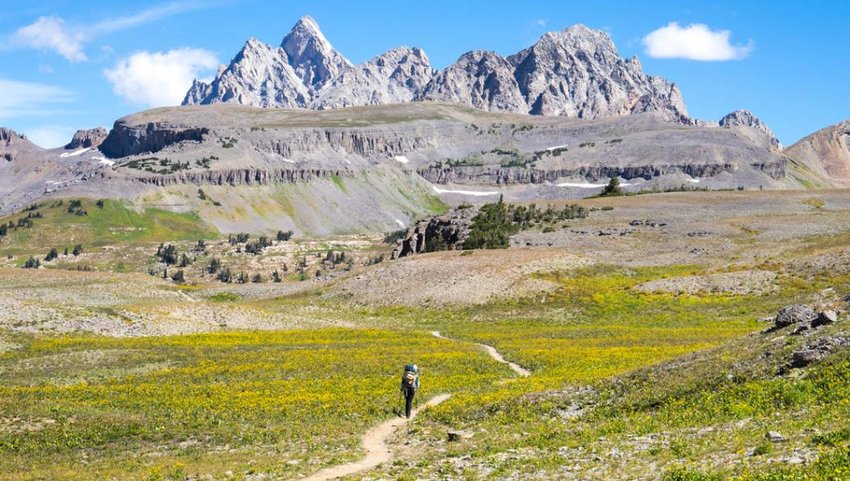 Backpacker hiking the Teton Crest Trail in Grand Teton National Park, Wyoming.