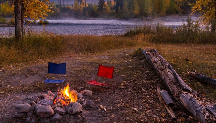 Chairs around a campfire in Glacier National Park