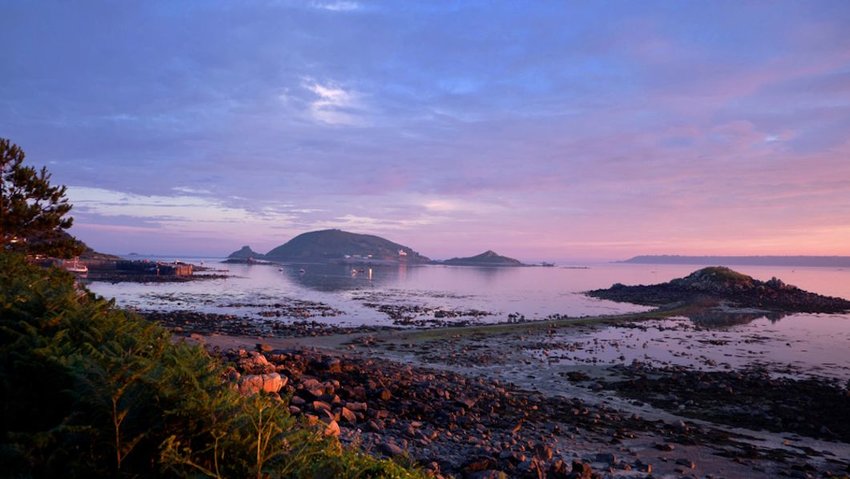 Purple sunset on beach of Herm island