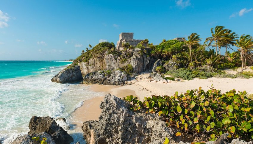 white sand beach with view of the Tulum Maya ruins