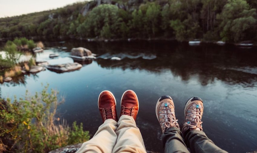 Travelers' hiking boots on mountain