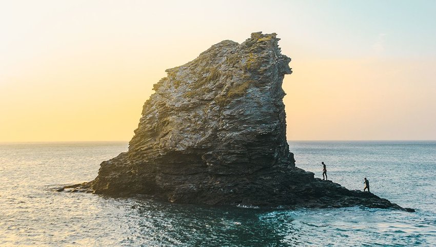 Two people exploring Trevellas Cove, Saint Agnes, United Kingdom