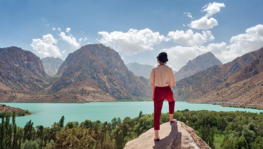 Woman overlooking Iskanderkul in the Fann Mountains, Tajikistan