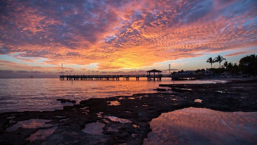 Orange sunset over pier at Key West Island, Florida