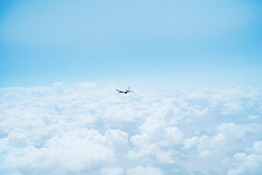 Plane flying above clouds.