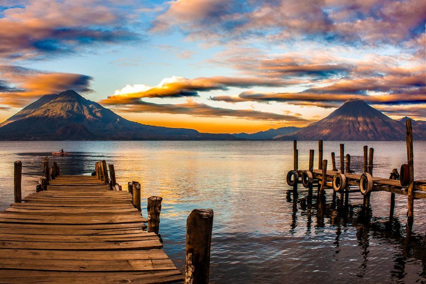 View of Lake Atitlan, Guatemala with mountains in background at sunset