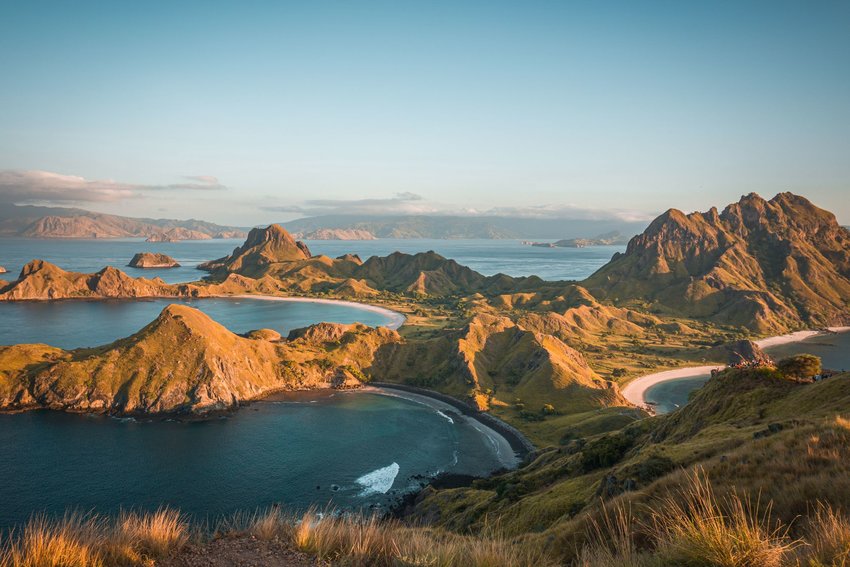 Mountainous peninsula surrounded by blue water. 