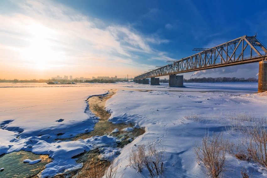 Railway bridge over the Ob river with Novosibirsk, Russia in the background.