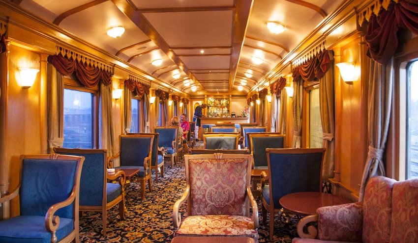 Interior of train cabin with seating and a bar 
