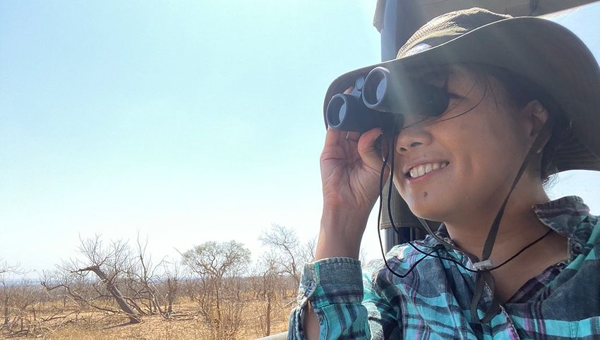 The author on a wildlife expedition, looking through binoculars