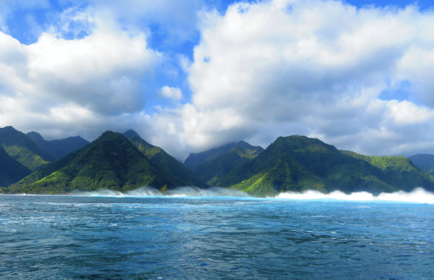 Waves crashing against the island of Tahiti