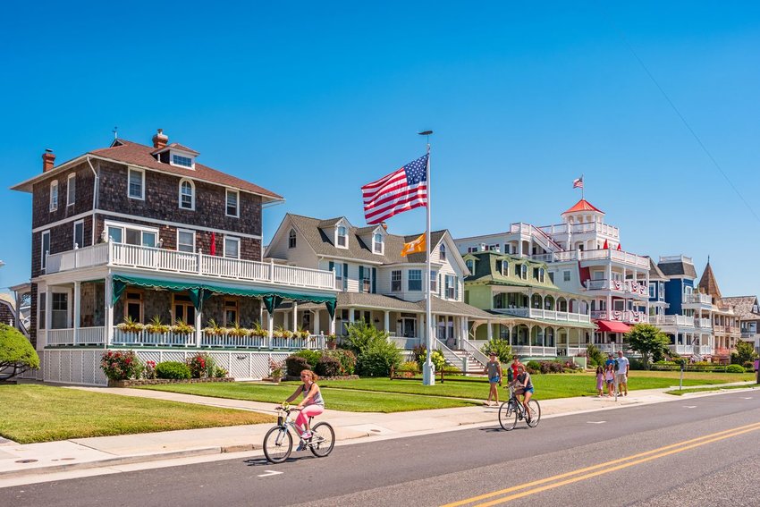 People walking and riding bikes along road in Cape May, New Jersey