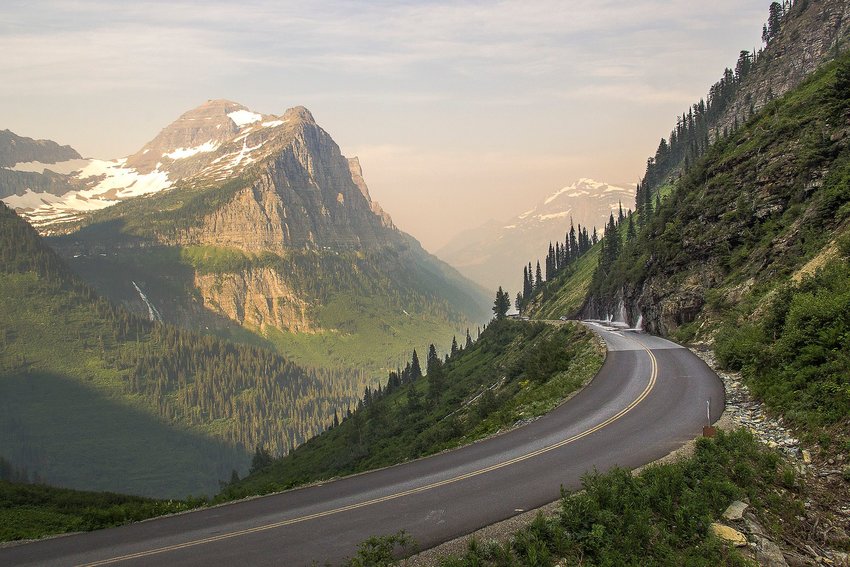 Going-to-the-Sun Road winding around the mountain with more mountains in background