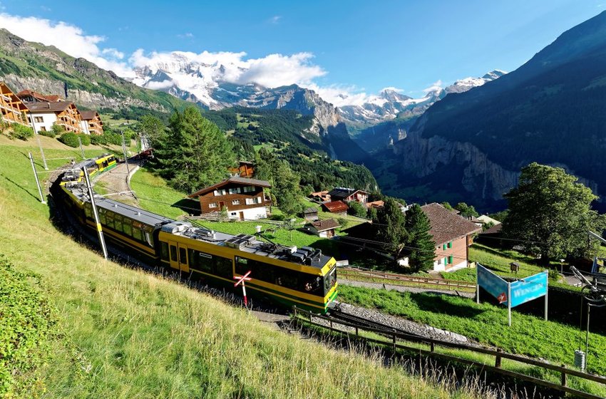 View of train traveling through the town of Wengen 