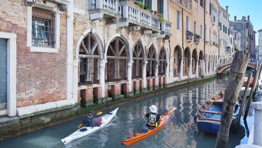 Two people kayaking in Venice's canals