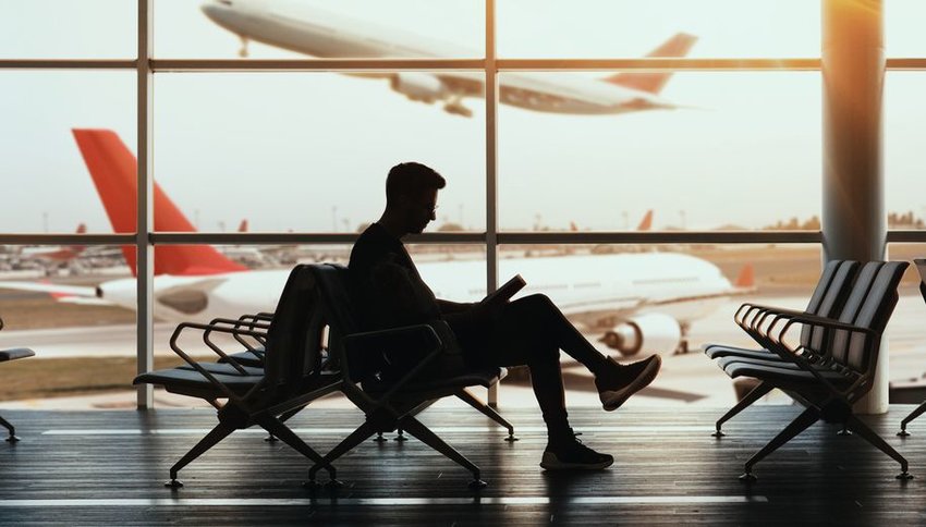 Man reading book at the airport