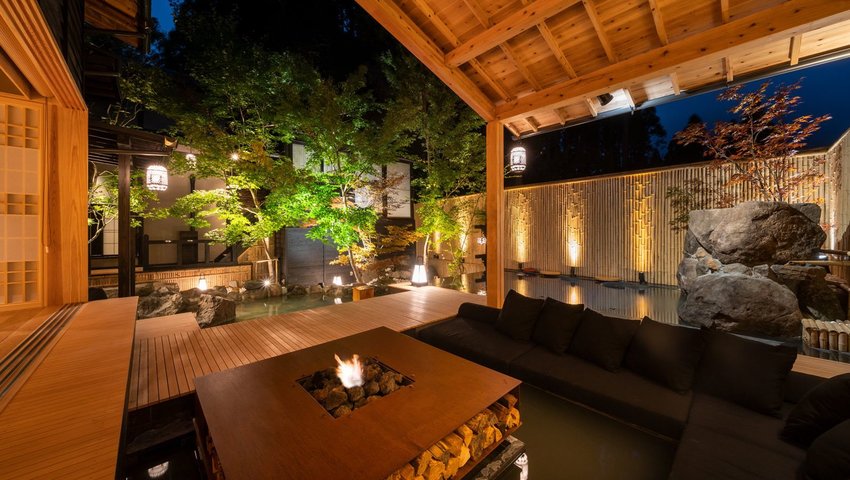 Exterior view of sitting area around fire pit in covered deck area