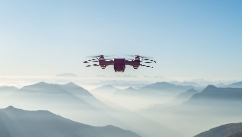 Drone in sky with mountain ranges in background