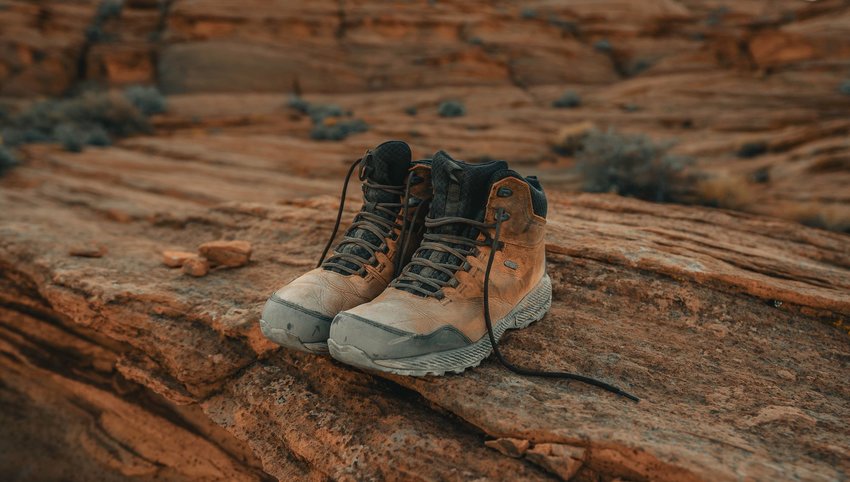 Pair of hiking boots sitting on red rock formation