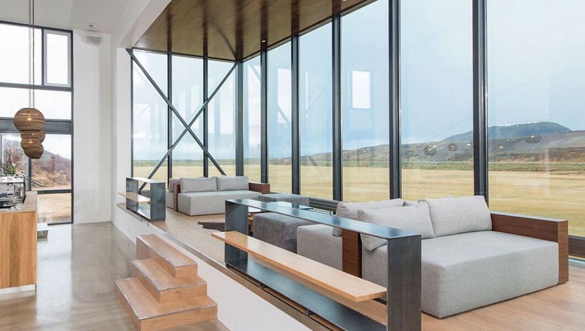 Interior of sitting room with floor to ceiling windows with views