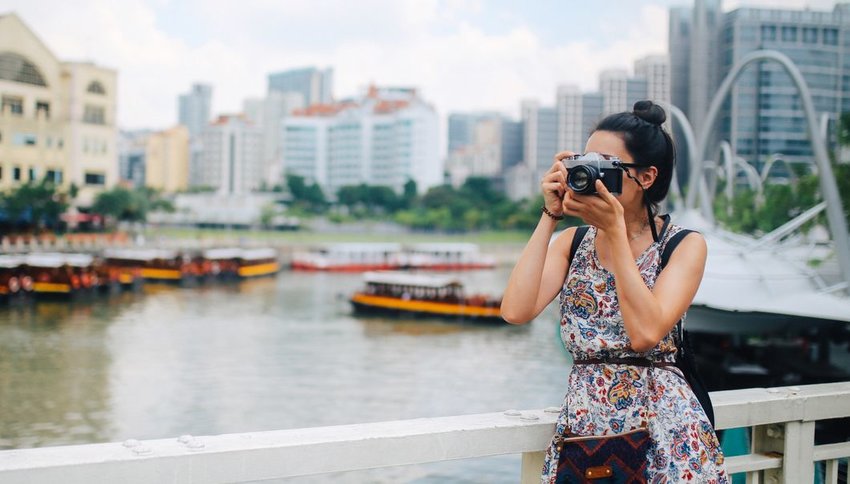 Woman taking photo with film camera