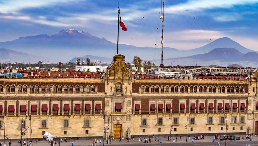Front exterior view of Palacio Nacional with mountain view in background 