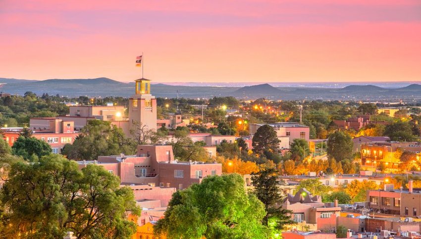 Skyline of Santa Fe with mountains in background at sunset