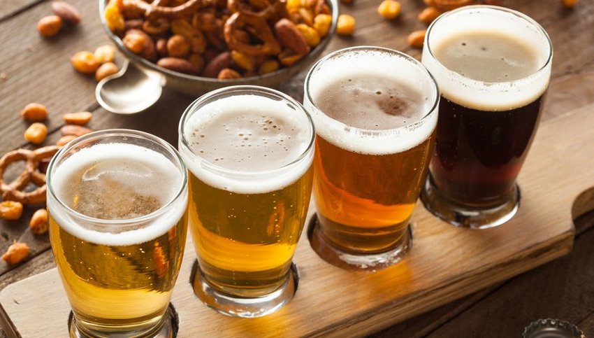 Flight of beer with assortment of pretzels and nuts