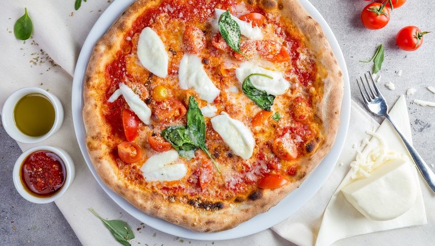 Margarita pizza with sauces and a fork