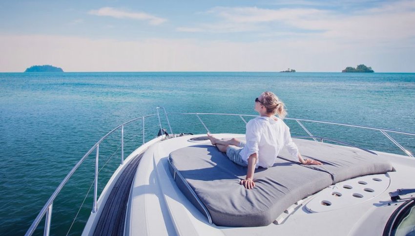 Person on front of boat looking out at the water