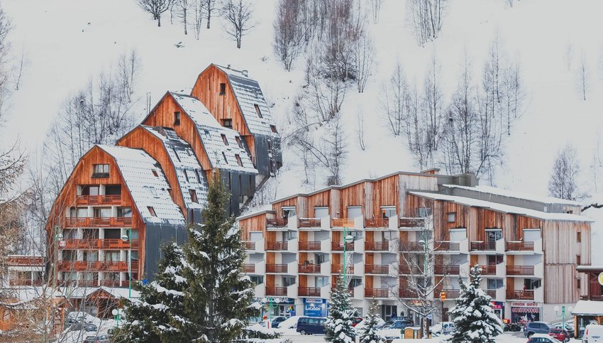 Hotel buildings covered in snow on snowy hillside