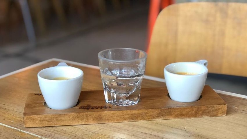 Coffee cups on wood plate on table