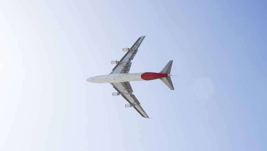 The underside of a plane flying through the sky