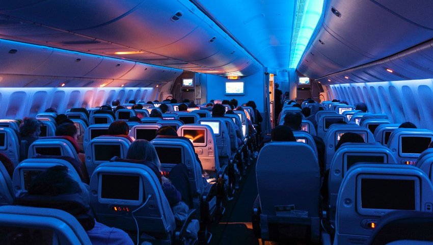 Interior of plane with lights dimmed in cabin