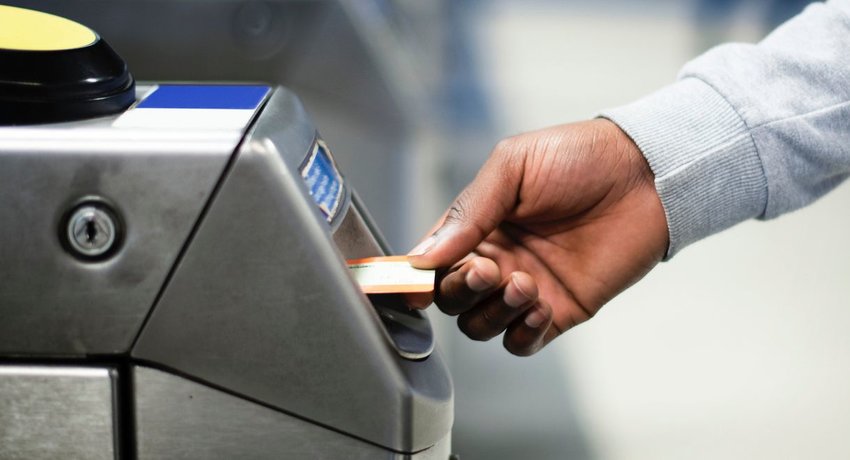 Person putting ticket into machine