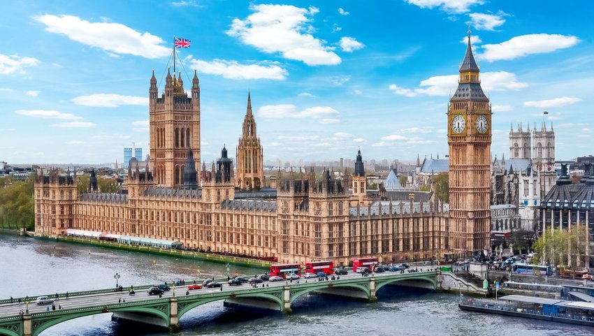 Big ben with cars on the bridge in front