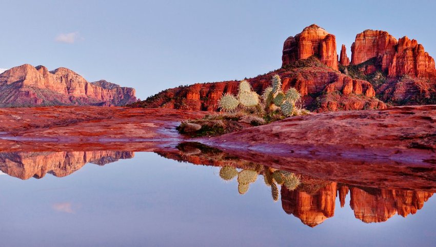 Reflection of red rocks landscape in water 