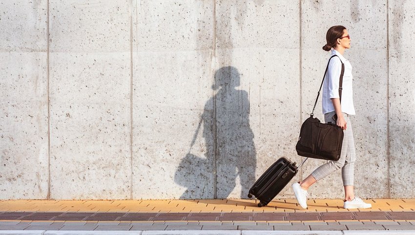 Woman walking down street with bags