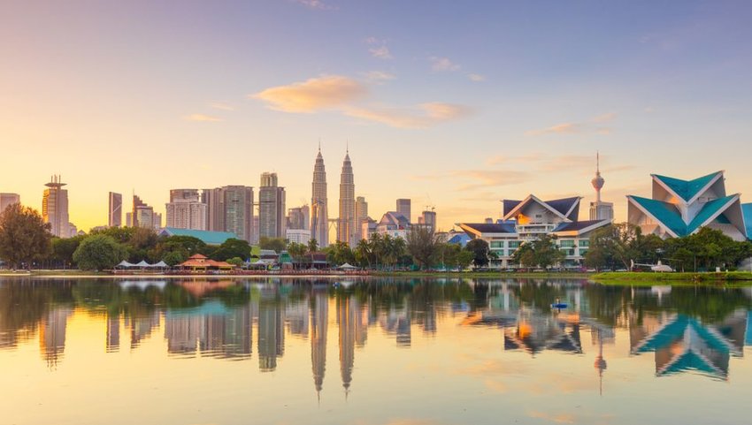 Panoramic view of Kuala Lumpur city waterfront skyline with reflections