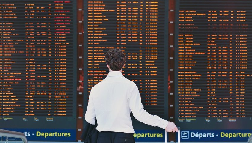 Person standing in front of flight board 