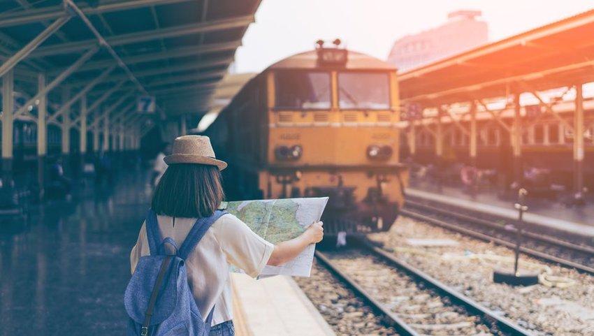 Woman looking at a map at a train station