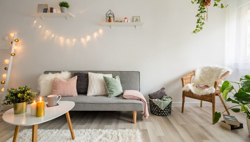 String lights, candles and plants in living room