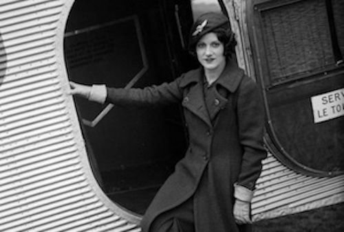 Ellen Church standing in front of an open plane door, circa 1930