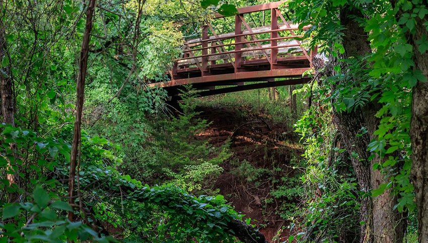 Wooden bridge in a lush green Oklahoma setting