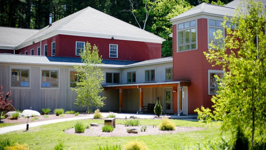 Exterior of red and grey building with grass in front