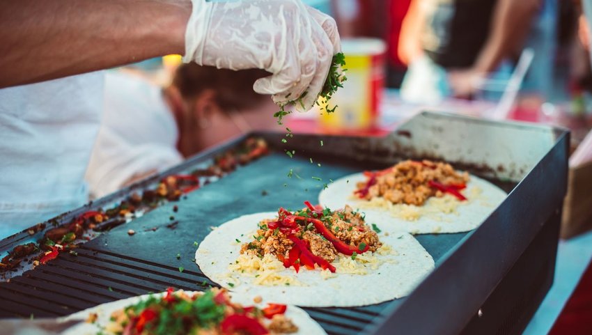 Person cooking fajitas on grill