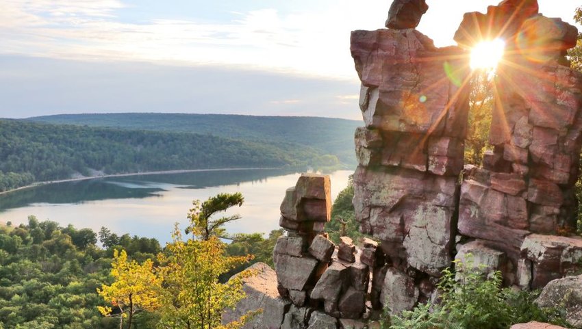 View over lake from rocky path on Ice Age Trail at sunset