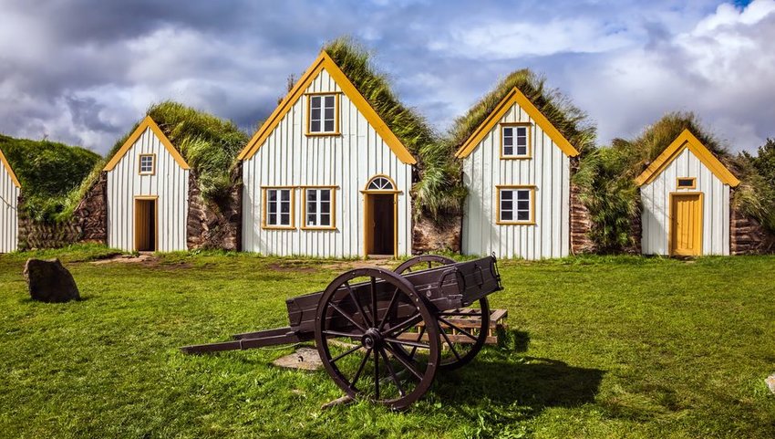 Farmhouses with wheel barrow in front
