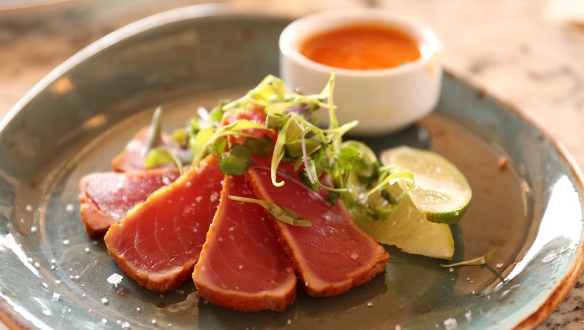 Raw fish on plate with sauce 