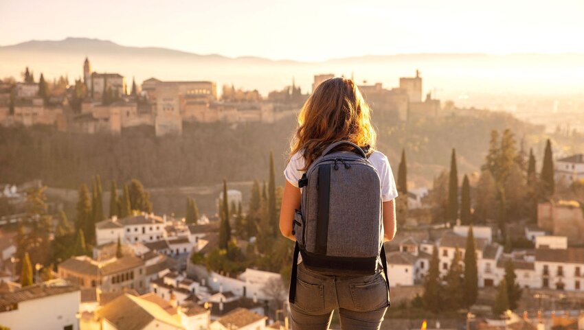 A woman tourist overlooking a mountain.